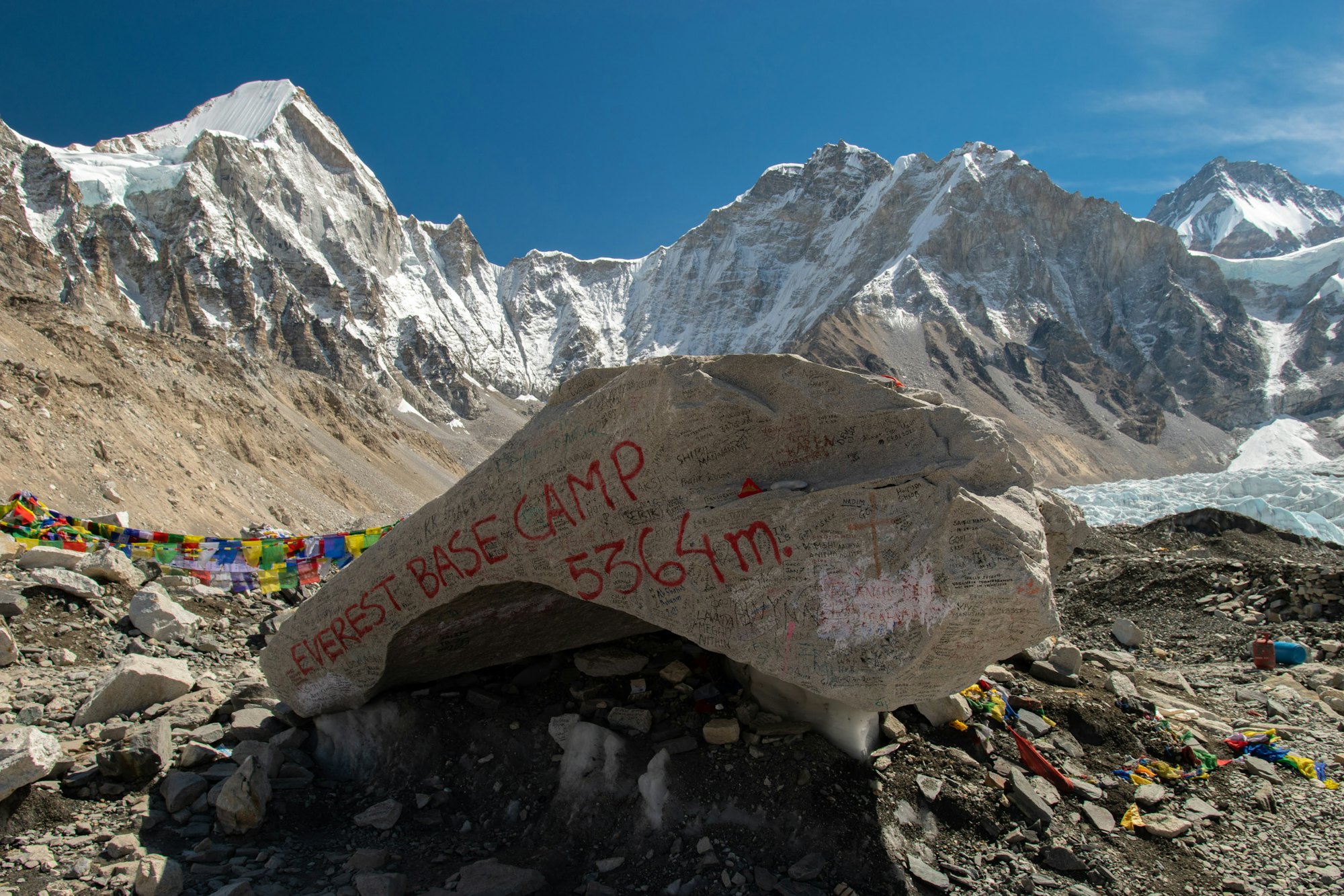 Everest Base Camp marker rock in front of the mountains