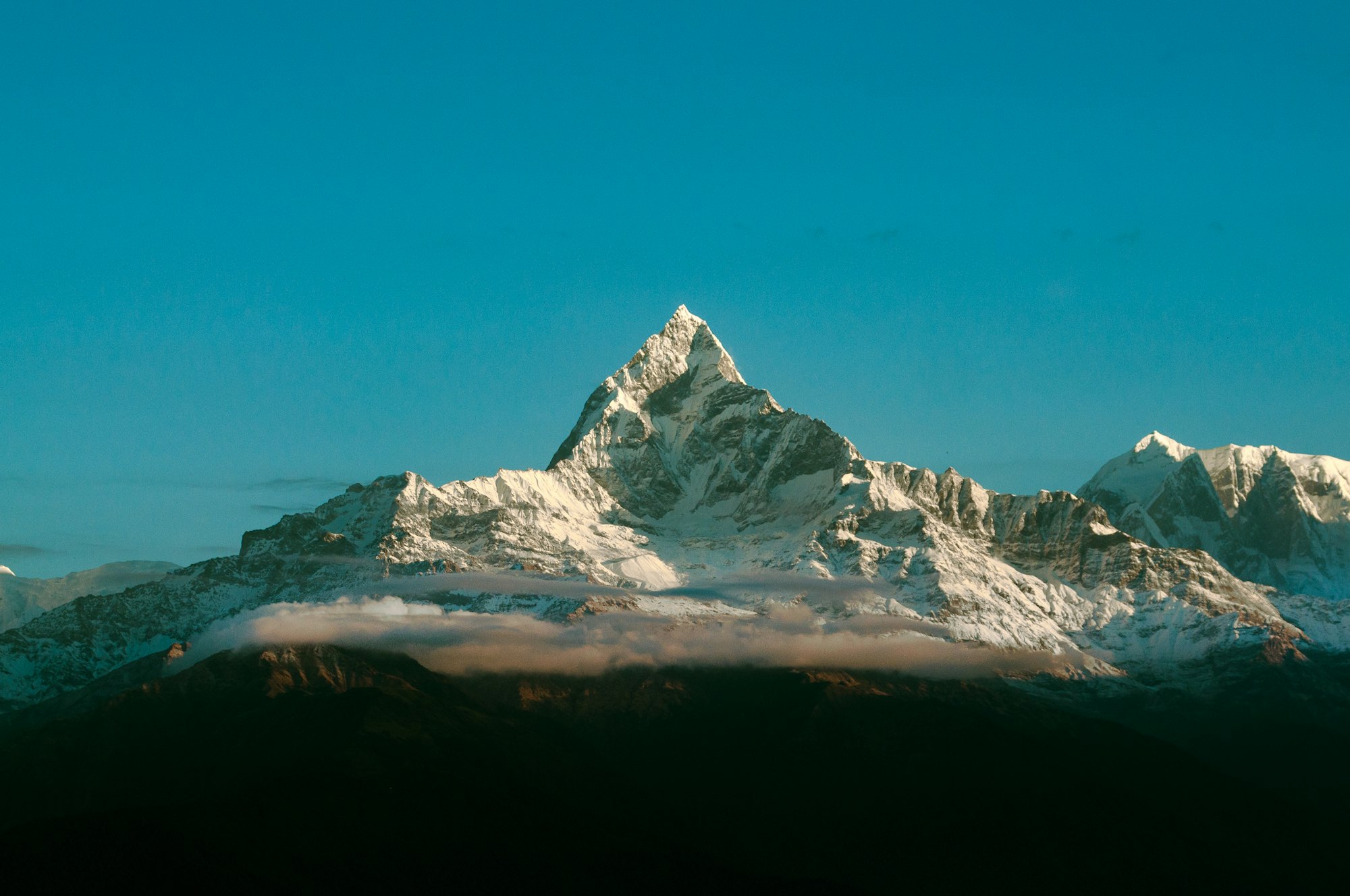 Snow-covered peak under a blue sky