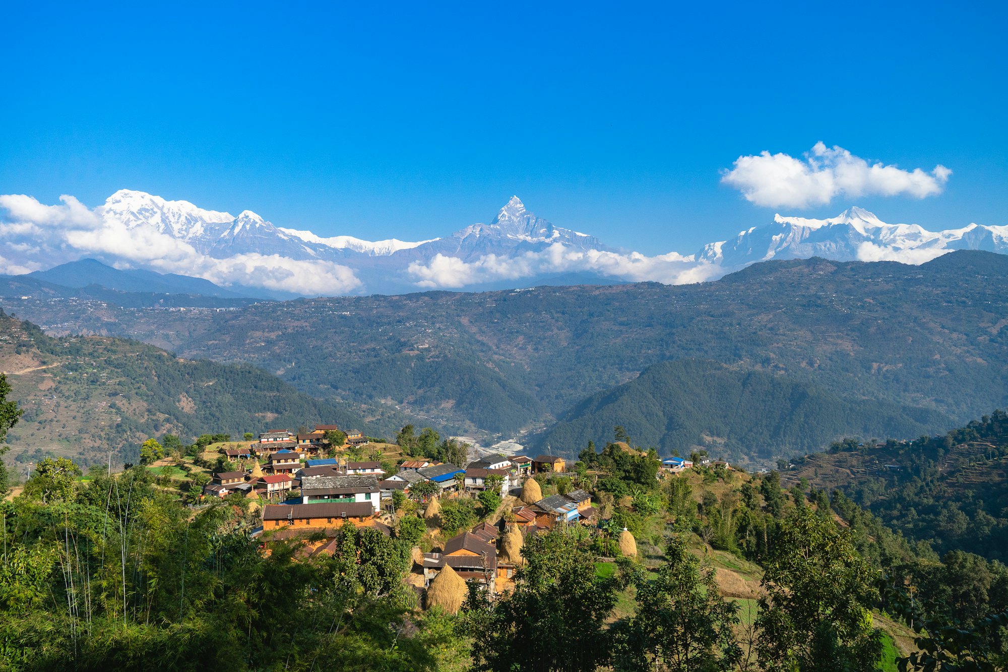 Hillside village with mountains behind